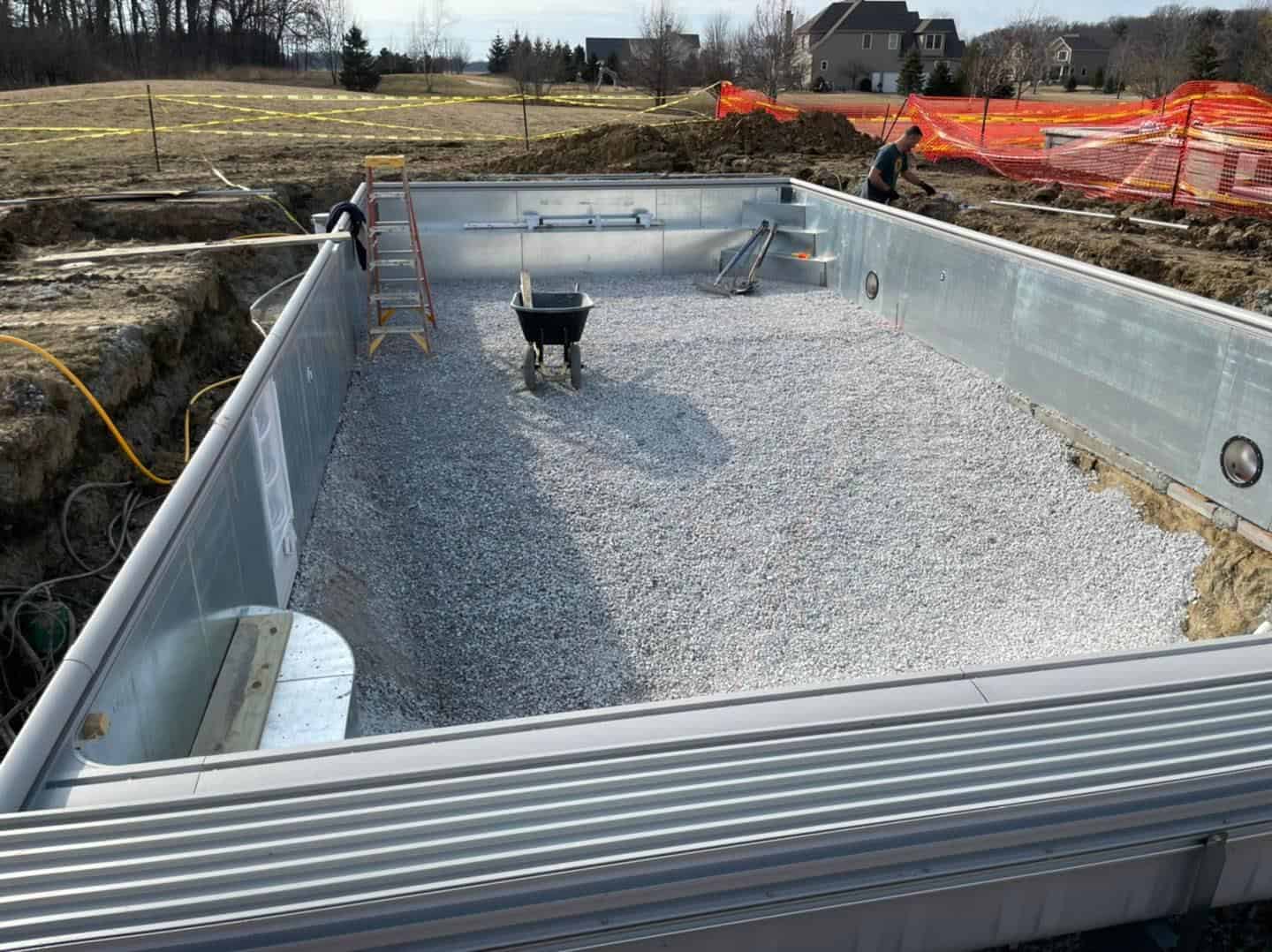 A swimming pool being built in the ground.