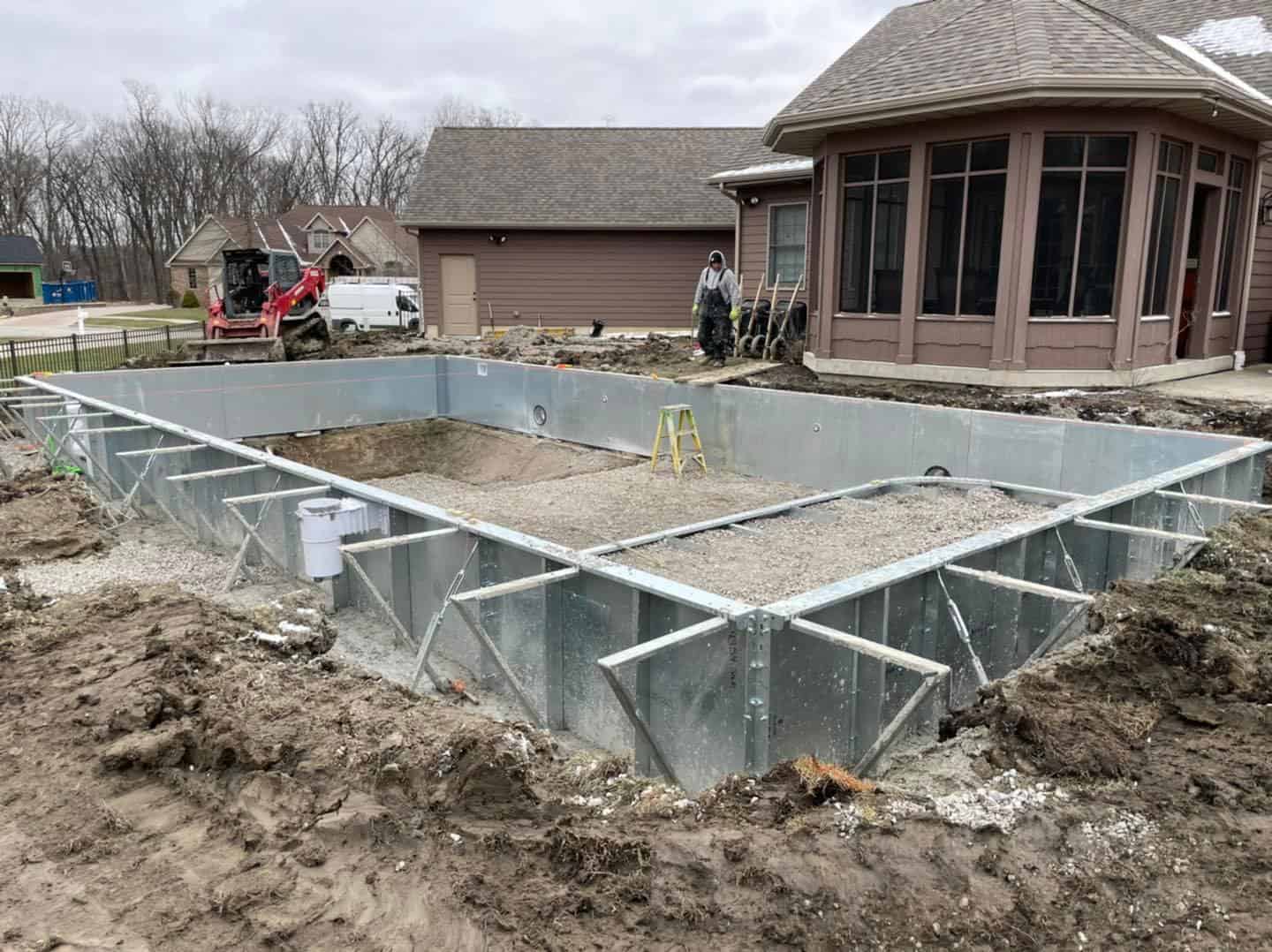 A swimming pool being built in a backyard.