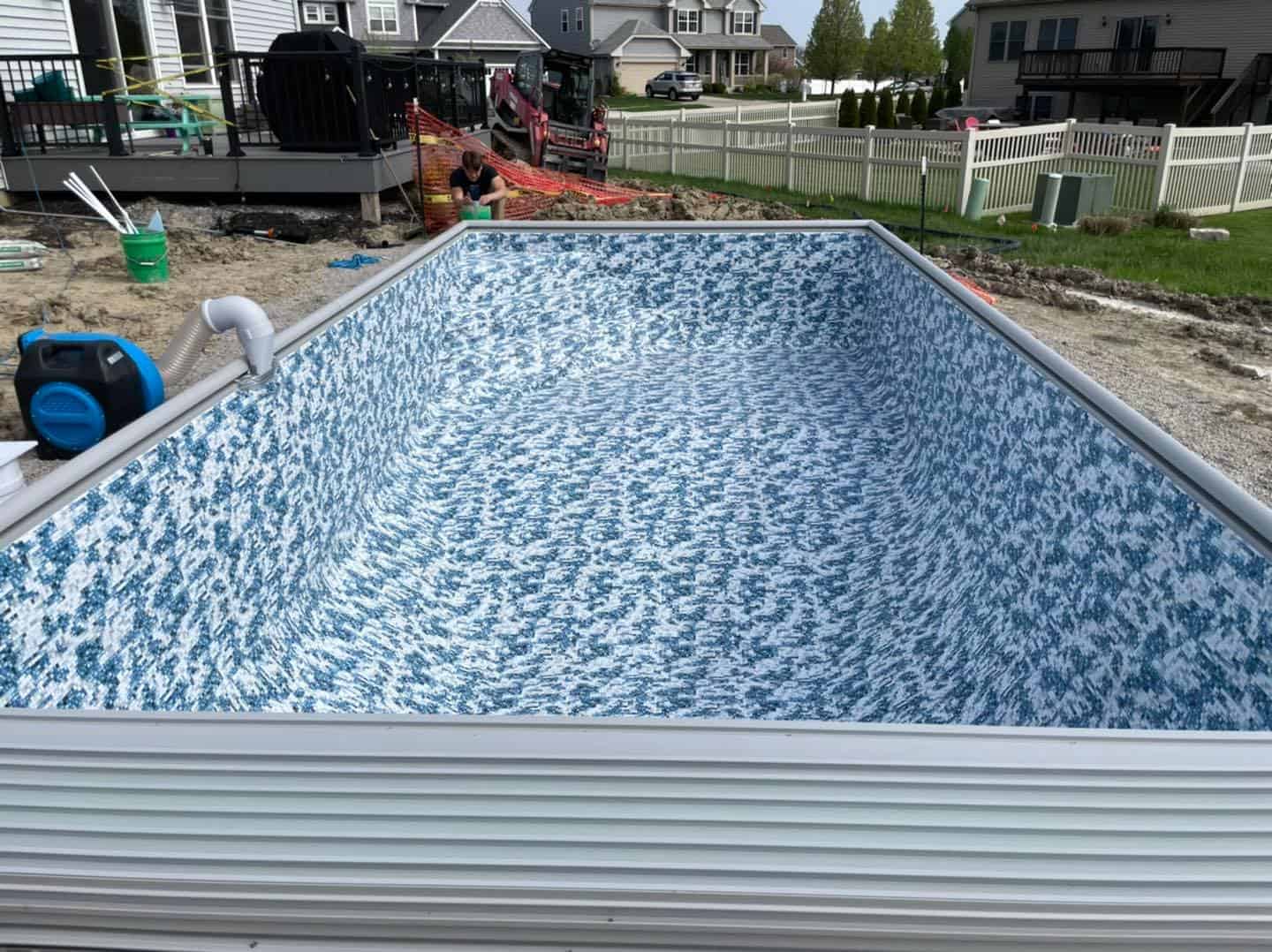 A swimming pool being built in a backyard.