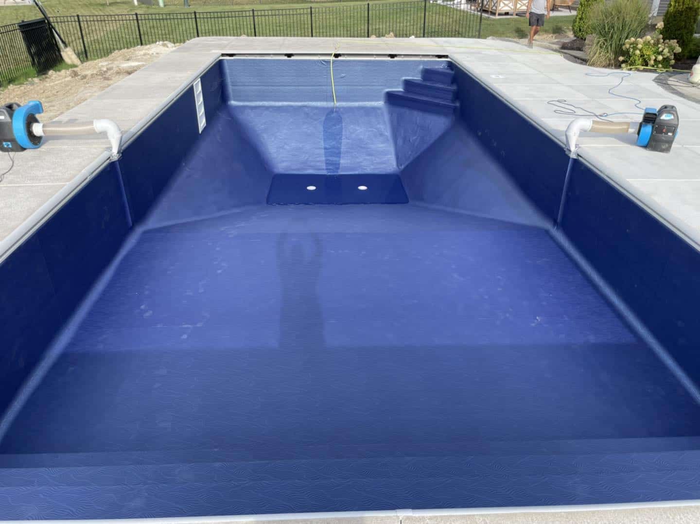 A blue swimming pool with a blue liner.