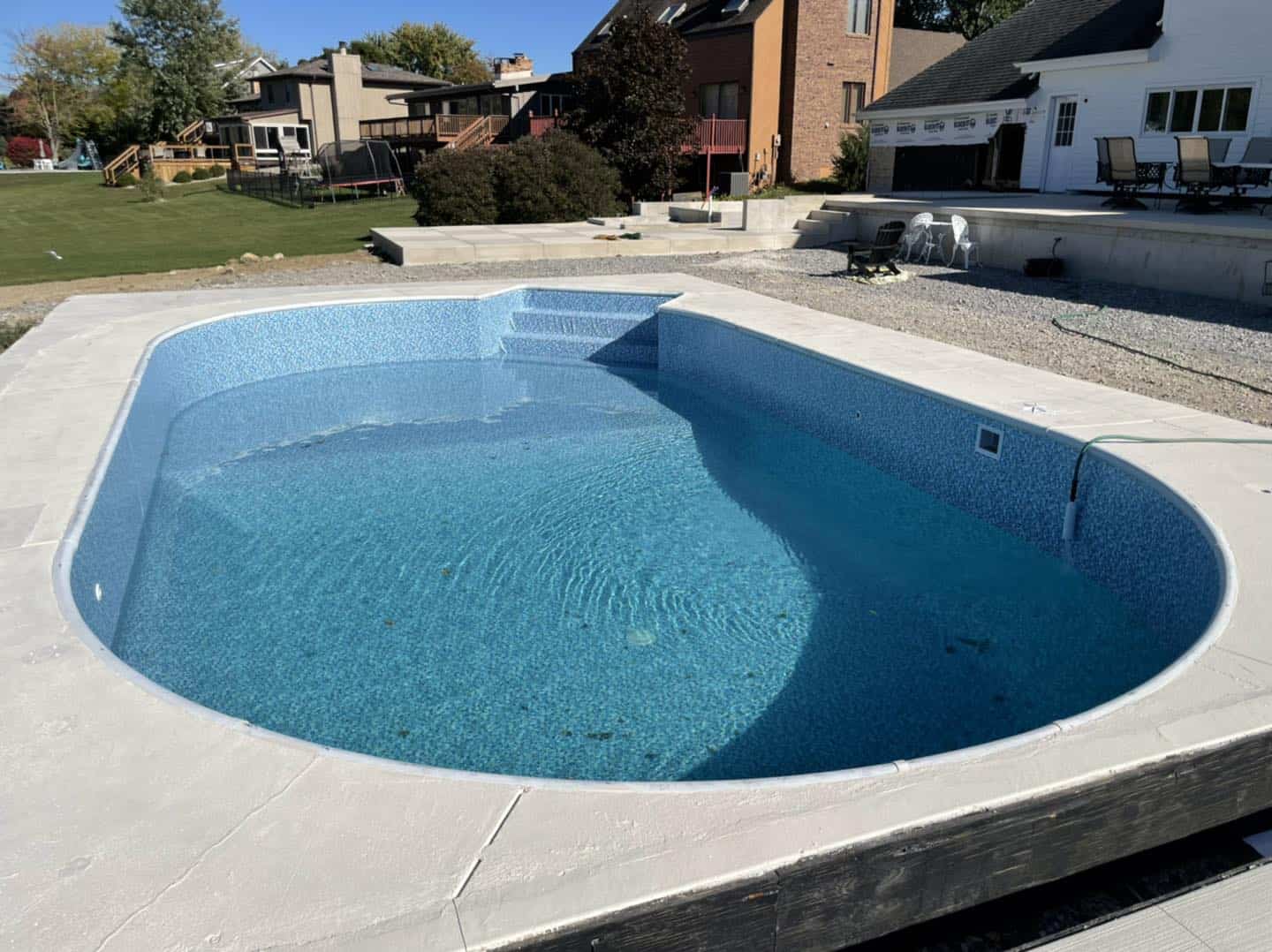 A swimming pool that has been installed in a backyard.