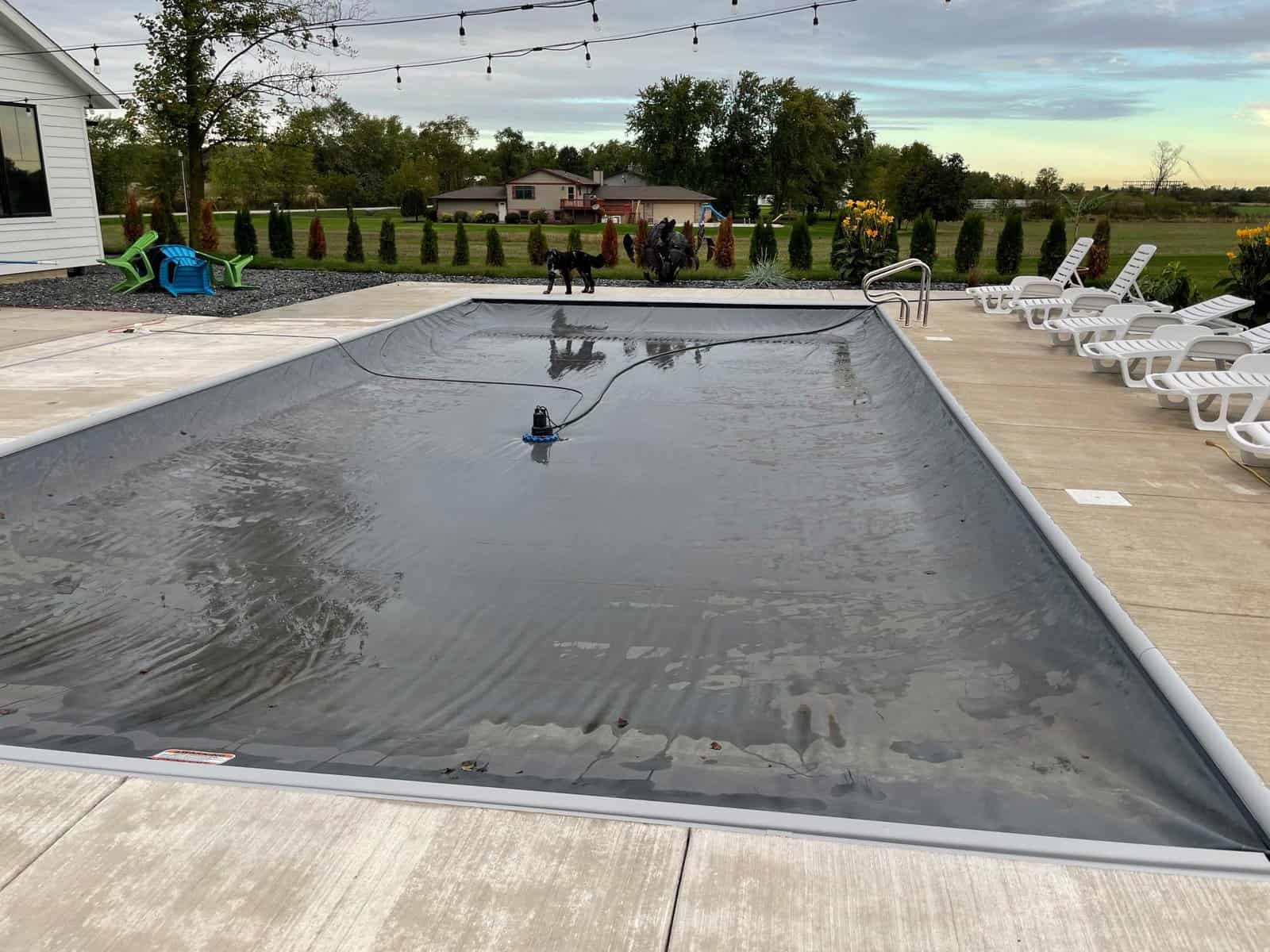 A swimming pool with a pool cover on it.