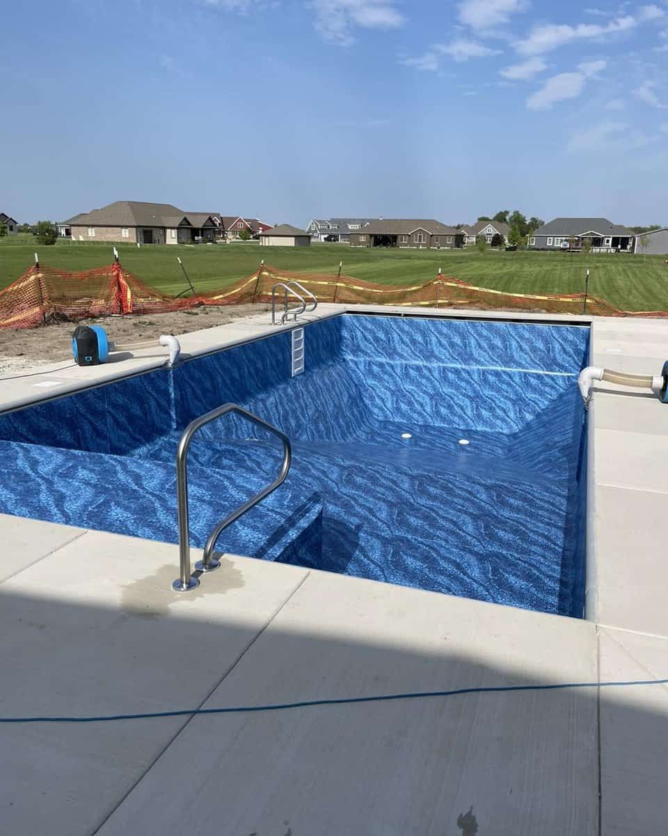 A swimming pool with a blue pool liner.
