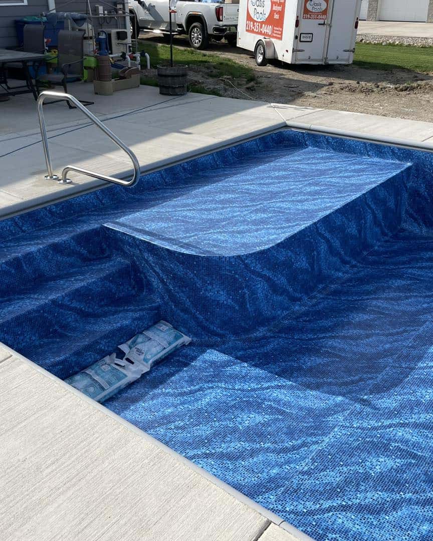 A swimming pool with a blue pool liner.