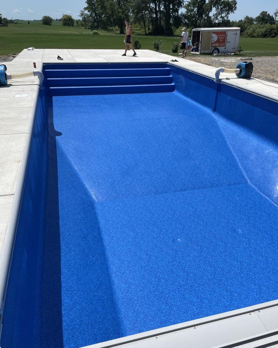 A blue swimming pool with a blue liner.