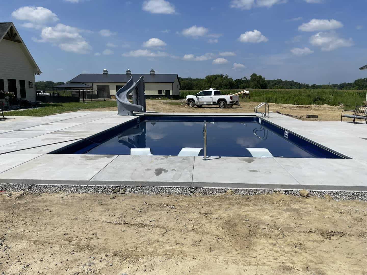A swimming pool is being built in a backyard.