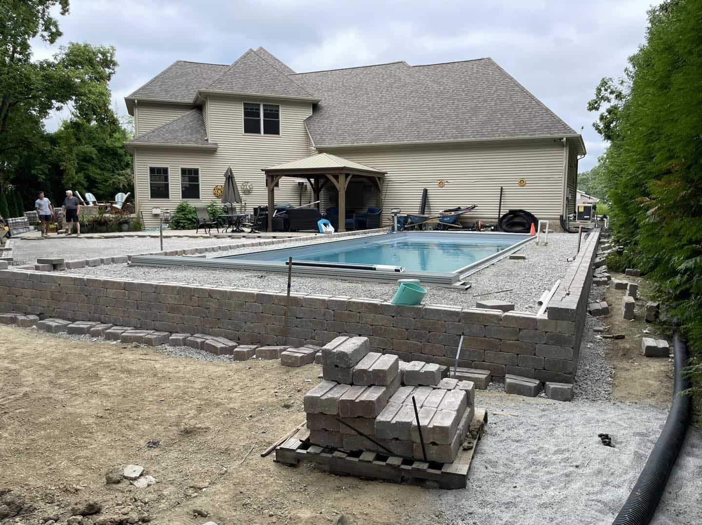 A swimming pool being built in front of a house.