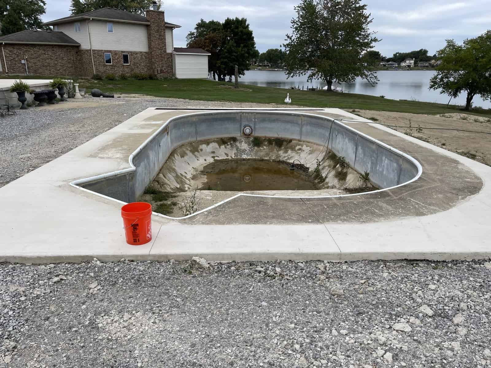 A swimming pool with a bucket in the middle of it.
